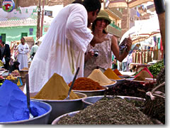 Bargaining for spices in the souk of Aswan, Egypt.