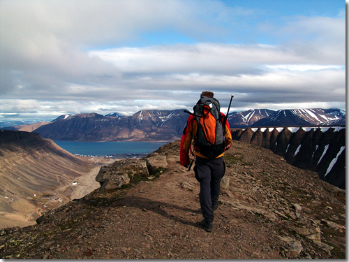 Elias leads a half-day hike to the top of Coffin Mountain above Longyearbyen (barely visible by the fjord below), the capital of Spitsbergen, Svalbard, Arctic Norway