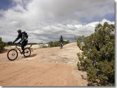 Mountain biking the slickrock of teh Klondike Bluffs between Moab and Arches National Park in Utah.