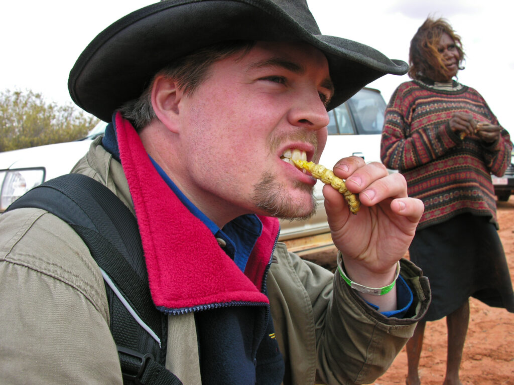 Enjoying a local delicacy, with Mary in the background